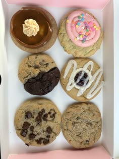 a box filled with different types of cookies and doughnuts on top of each other