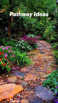 a stone path surrounded by flowers and trees