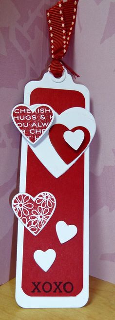 a red and white tag with hearts on it