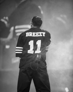 a black and white photo of a man wearing a jersey