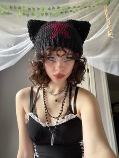 a woman wearing a cat hat with beads