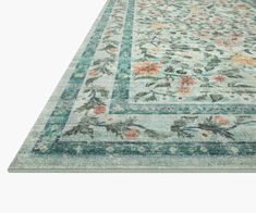 an area rug with flowers and leaves on the bottom, in light blue tones is shown