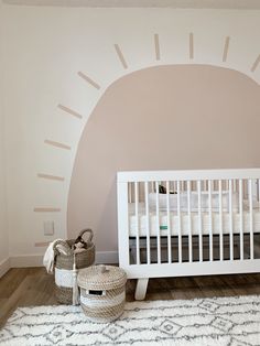 a baby's room with a white crib and rug