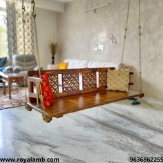 a wooden swing in the middle of a living room