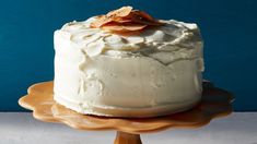 a close up of a cake on a plate with a blue wall in the background