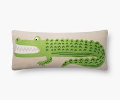 a pillow with a green crocodile on it's side and an open mouth in the middle