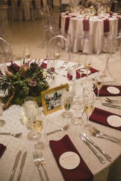 the table is set with wine glasses, silverware and place settings for an event