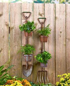 there are many potted plants and gardening tools hanging on the wall next to each other