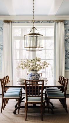 a dining room with blue and white wallpaper