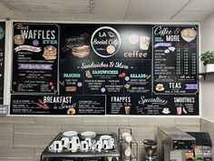 the menus on the wall are written in black and white letters, along with coffee cups