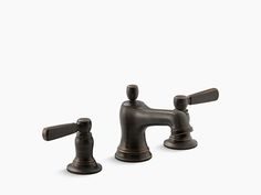 two faucets with bronze handles on white background