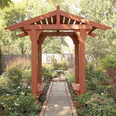 an outdoor garden with flowers and plants around the area, including a pergolated gazebo