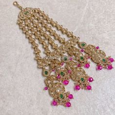 Antique gold and golden zircon jhumar with green gems and bright pink beads.  Ready to ship with Gift packaging as standard. Bollywood Jeweled Tikka For Festive Occasions, Festive Bollywood Jeweled Tikka, Gold Chandbali Jeweled Tikka, Gold Jeweled Chandbalis In Bollywood Style, Gold Jeweled Bollywood Tikka, Pink Stone Work Tikka For Festive Occasions, Festive Gold Jeweled Kundan Necklace, Traditional Jeweled Tikka For Celebrations, Heavy Elegant Gold Dupatta