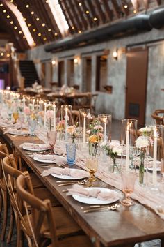 a long table is set with candles and flowers for a formal dinner or wedding reception