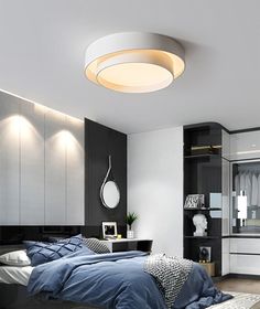 a bed room with a neatly made bed and a round light above the headboard