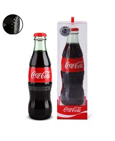 a bottle of coca cola sitting in front of a box