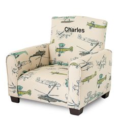 an upholstered chair with airplanes and planes on the back, sitting in front of a white background