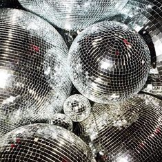 many shiny disco balls are stacked together