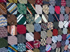 many different types of ties are arranged in a quilted pattern on the side of a wall