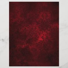 a red and black background with swirls on the edges, in shades of burgundy