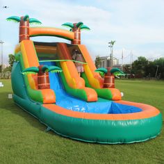 an inflatable water slide with palm trees on it