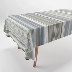 a striped tablecloth with wooden legs on an isolated white background for use in furniture design