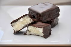 three pieces of chocolate with white frosting on a plate