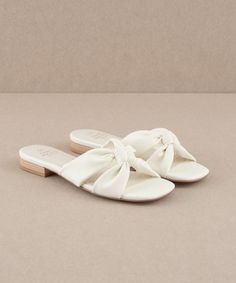 20% off at https://lithologieco.com/collections/shoes/products/kori-knot-flat-sandals-off-white Designed for a stylish minimalist, these knotted sandals are a versatile addition to any wardrobe. Heel Height: 0.75" Type of Closure: Slip On Upper Material: Vegan Leather Upper Insole Material: Padded Insole Hoco Shoes Flats, White Sandals Flat, White Flat Sandals, Random Products, Sandal Slippers, Greece Trip, Slippers Summer, Womens Sandals Summer, Wrap Heels