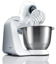 a white mixer with a metal bowl on it