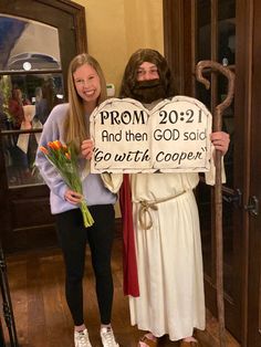 two people dressed as jesus and mary holding a sign that says prom 2012 and then god said go with copper