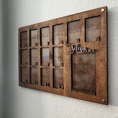 a wooden wall mounted calendar on the wall