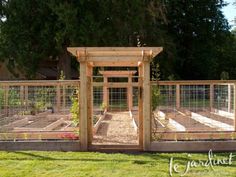 an outdoor vegetable garden with fencing around it