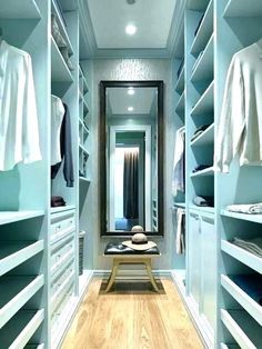 an empty walk in closet with lots of clothes