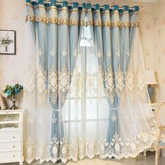 the curtains in this room are blue and white with gold trimmings on them