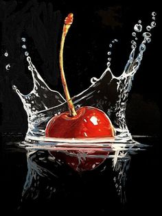 an apple with water splashing on it