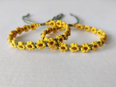 two bracelets made out of yellow and green beads