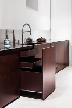 a kitchen with an island sink and wooden cabinetry in it's center area