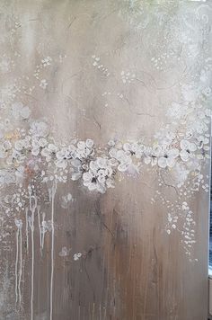 an abstract painting with white flowers on a brown background and water dripping from the bottom