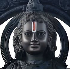 a statue with a red and white stripe on it's forehead