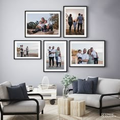 a living room with four pictures hanging on the wall and two couches in front of them