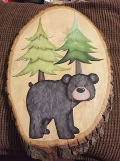 the bear is standing in front of trees painted on a piece of wood that has been cut out