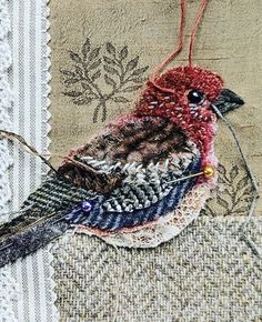 an embroidered bird sitting on top of a piece of fabric with the words instagram