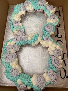 a cake in a box decorated with flowers and icing