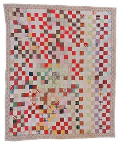 an old quilt with many squares on the front and back, all in different colors