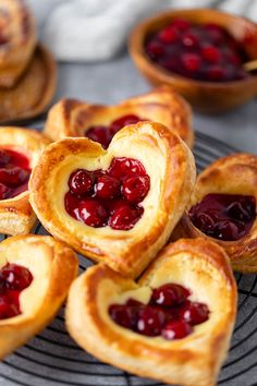 heart shaped pastries with cherries in the middle