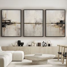 a living room with three paintings on the wall