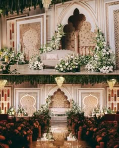 an elaborate wedding setup with flowers and greenery