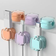 an assortment of colorful luggage plugs attached to a white wall with wires in them