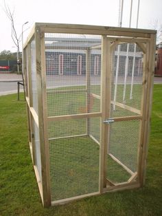 a chicken coop in the middle of some grass