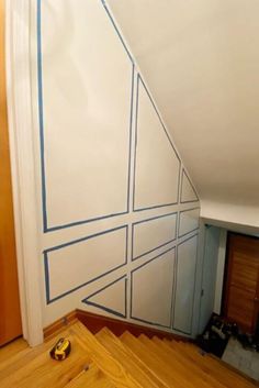 an unfinished room with blue lines painted on the wall and wood flooring in front of it